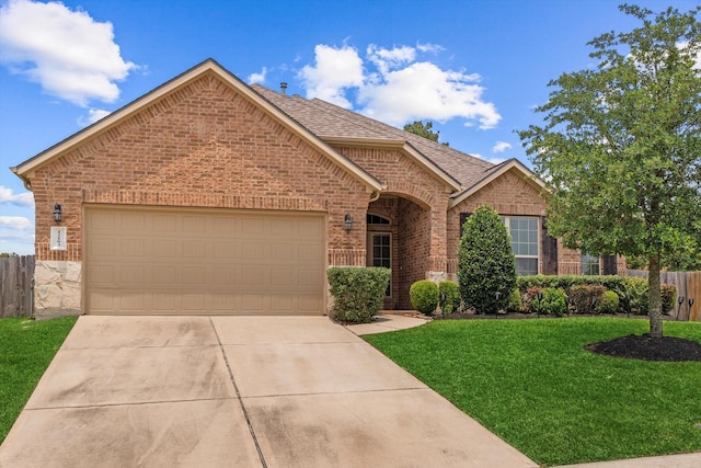 12103 Kaiso Ln, Conroe, TX 77304 - view of front of home featuring brick siding, driveway, an attached garage, and roof with shingles
