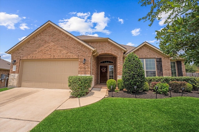 12103 Kaiso Ln, Conroe, TX 77304 - view of front of home with brick siding, concrete driveway, an attached garage, and a front yard