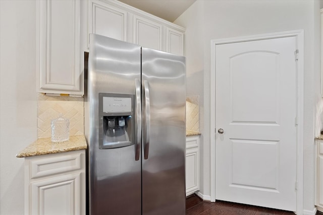 12103 Kaiso Ln, Conroe, TX 77304 - kitchen with stainless steel fridge, backsplash, light stone counters, and dark wood-type flooring