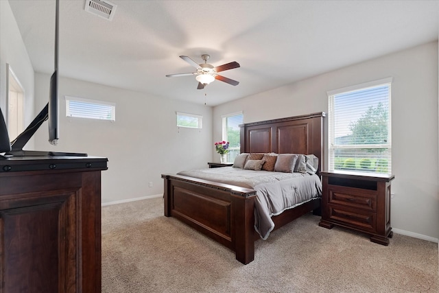 12103 Kaiso Ln, Conroe, TX 77304 - bedroom with light colored carpet, multiple windows, and baseboards
