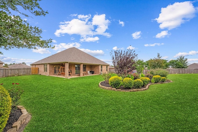12103 Kaiso Ln, Conroe, TX 77304 - rear view of house featuring brick siding, a patio area, and a shingled roof
