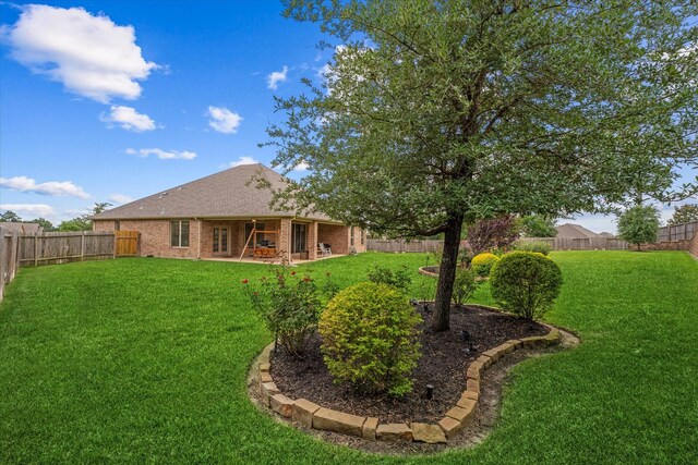 12103 Kaiso Ln, Conroe, TX 77304 - back of house featuring brick siding and roof with shingles