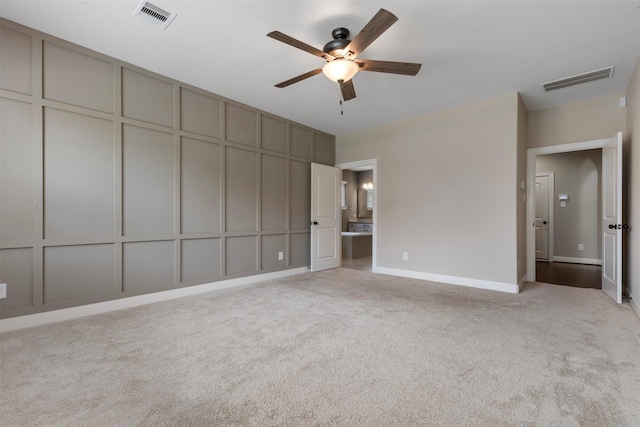 15002 House Martin Ln, Cypress, TX 77429 - unfurnished bedroom with carpet flooring, baseboards, a decorative wall, ensuite bathroom, and a ceiling fan