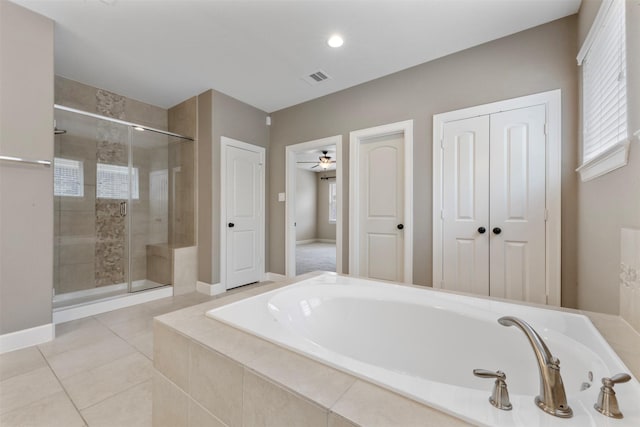15002 House Martin Ln, Cypress, TX 77429 - full bath with a bath, a stall shower, tile patterned floors, a ceiling fan, and baseboards