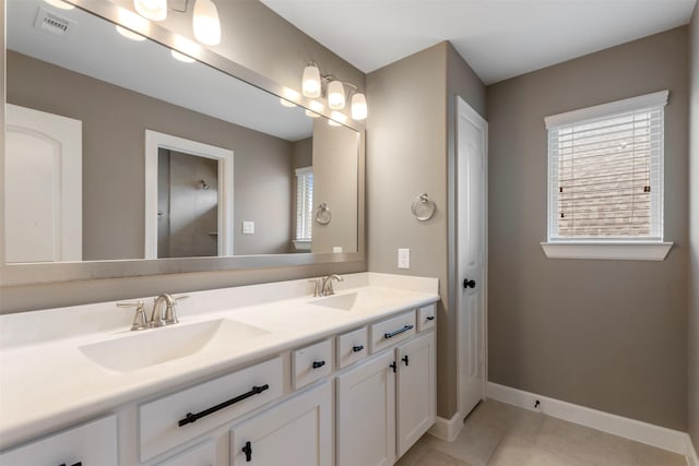15002 House Martin Ln, Cypress, TX 77429 - bathroom with double vanity, baseboards, and tile patterned flooring