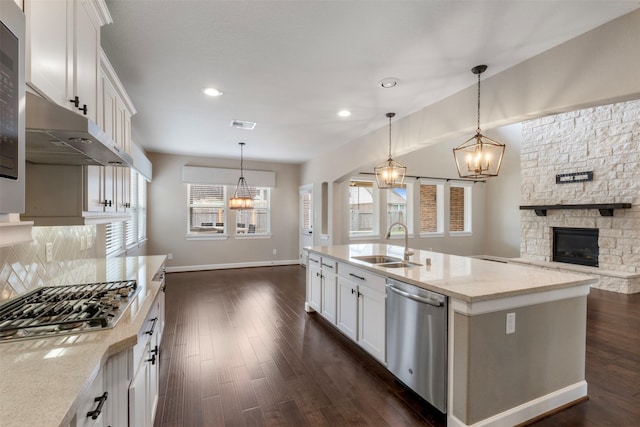15002 House Martin Ln, Cypress, TX 77429 - kitchen featuring stainless steel appliances, a chandelier, a sink, a fireplace, and recessed lighting