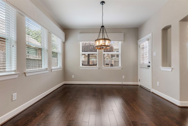 15002 House Martin Ln, Cypress, TX 77429 - unfurnished dining area with a chandelier, dark wood-style floors, and baseboards