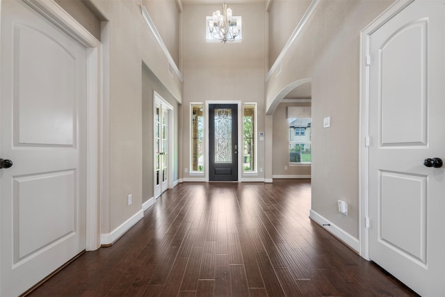 15002 House Martin Ln, Cypress, TX 77429 - entrance foyer featuring a chandelier, dark wood finished floors, arched walkways, baseboards, and a towering ceiling