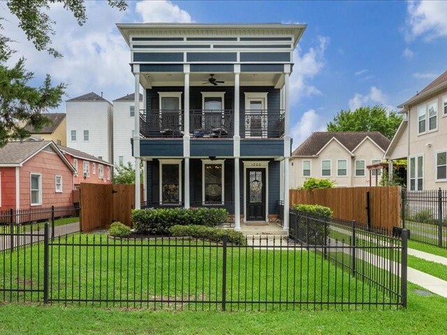 1200 W 24th St, Houston, TX 77008 - view of front of home with a balcony, ceiling fan, a fenced front yard, and covered porch