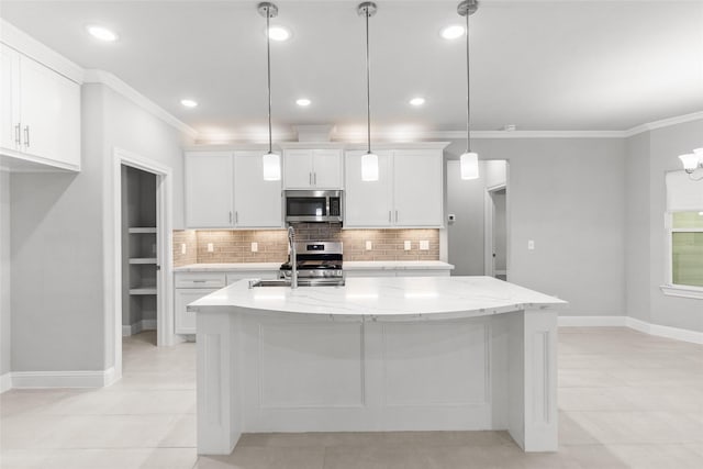 116 Augusta Dr, Huntsville, TX 77340 - kitchen with stainless steel appliances, ornamental molding, decorative backsplash, white cabinets, and a center island with sink