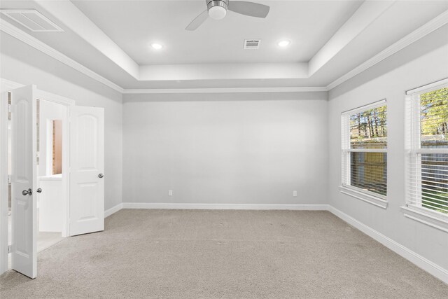 116 Augusta Dr, Huntsville, TX 77340 - spare room with light carpet, a raised ceiling, ceiling fan, baseboards, and crown molding