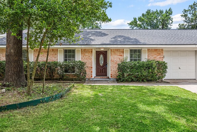 2113 Timber Ln, Conroe, TX 77301 - single story home featuring an attached garage, brick siding, a front yard, and roof with shingles
