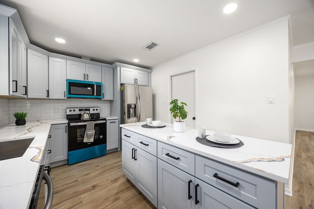 2113 Timber Ln, Conroe, TX 77301 - kitchen with range with electric cooktop, stainless steel fridge, light wood-style flooring, ornamental molding, and tasteful backsplash
