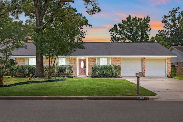 2113 Timber Ln, Conroe, TX 77301 - view of front of house with driveway, brick siding, a garage, and a yard