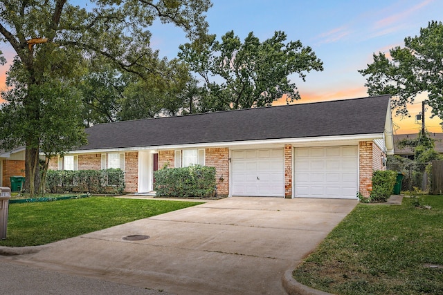 2113 Timber Ln, Conroe, TX 77301 - view of front of home featuring brick siding, an attached garage, and driveway