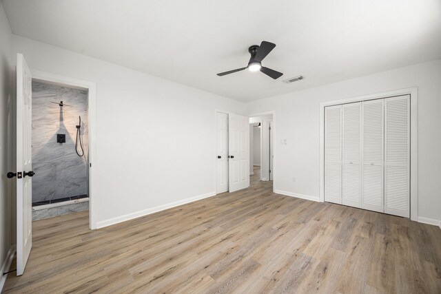 2113 Timber Ln, Conroe, TX 77301 - unfurnished bedroom with wood finished floors, baseboards, and ceiling fan