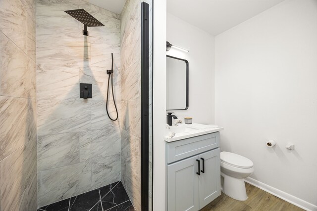 2113 Timber Ln, Conroe, TX 77301 - full bath featuring a marble finish shower, vanity, toilet, and baseboards