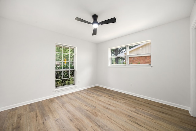 2113 Timber Ln, Conroe, TX 77301 - spare room featuring baseboards, wood finished floors, healthy amount of natural light, and a ceiling fan