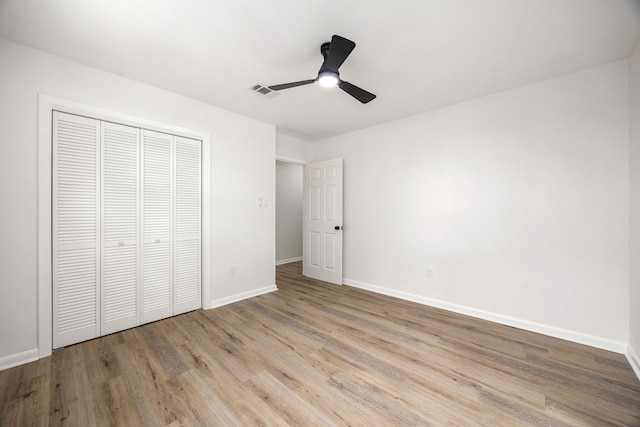 2113 Timber Ln, Conroe, TX 77301 - unfurnished bedroom featuring baseboards, wood finished floors, a closet, and ceiling fan