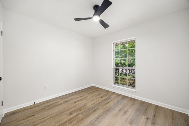 2113 Timber Ln, Conroe, TX 77301 - spare room featuring wood finished floors, baseboards, and ceiling fan