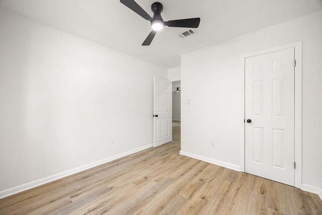 2113 Timber Ln, Conroe, TX 77301 - unfurnished bedroom with light wood-type flooring, baseboards, and ceiling fan