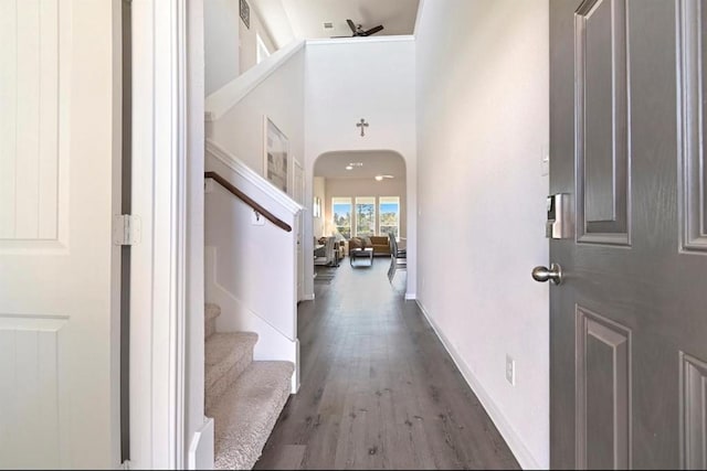 23523 Montague Dr, Spring, TX 77373 - foyer with stairs, wood finished floors, arched walkways, a high ceiling, and baseboards