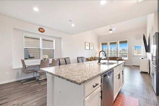 23523 Montague Dr, Spring, TX 77373 - kitchen featuring a sink, stainless steel dishwasher, dark wood finished floors, a kitchen island with sink, and white cabinetry