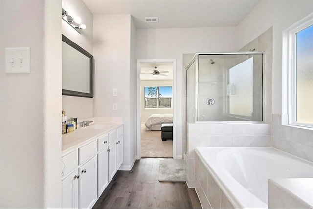 23523 Montague Dr, Spring, TX 77373 - ensuite bathroom with a bath, vanity, a shower stall, wood finished floors, and a ceiling fan