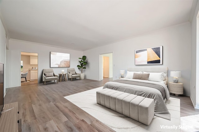 2400 N Braeswood Blvd Unit 106, Houston, TX 77030 - bedroom featuring light wood finished floors, crown molding, and baseboards