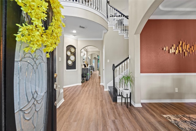 3707 Doyle Ct, Missouri City, TX 77459 - entrance foyer with arched walkways, stairs, wood finished floors, ornamental molding, and baseboards