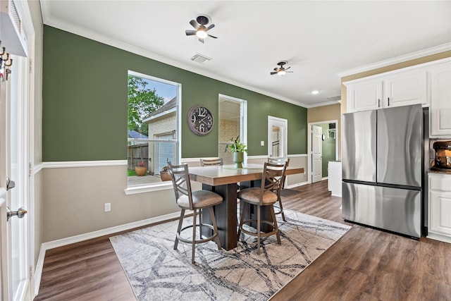 3707 Doyle Ct, Missouri City, TX 77459 - dining area featuring crown molding, dark wood-type flooring, and baseboards