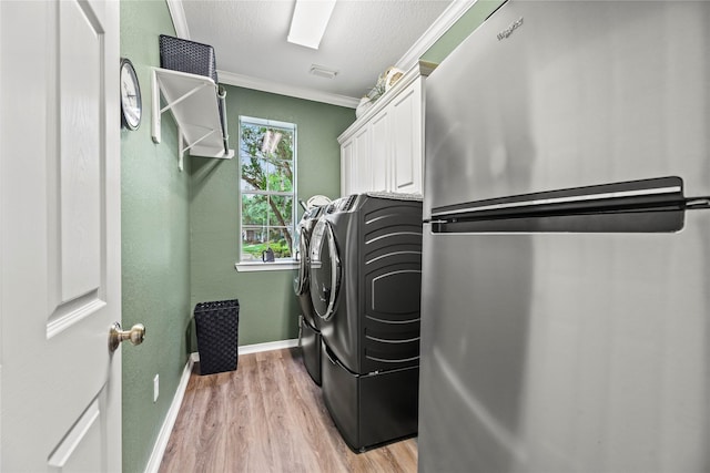 3707 Doyle Ct, Missouri City, TX 77459 - washroom featuring washer and dryer, ornamental molding, light wood finished floors, baseboards, and cabinet space