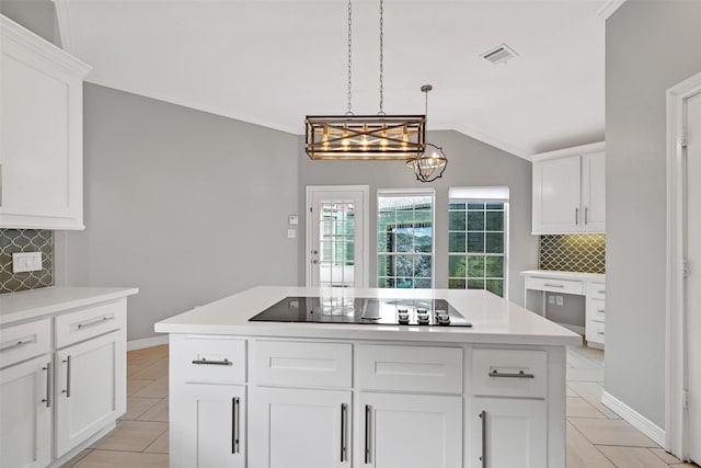408 Pine Creek Dr, Friendswood, TX 77546 - kitchen with black electric cooktop, light tile patterned flooring, backsplash, light countertops, and vaulted ceiling