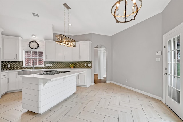 408 Pine Creek Dr, Friendswood, TX 77546 - kitchen with a sink, a chandelier, black stovetop, tasteful backsplash, and crown molding
