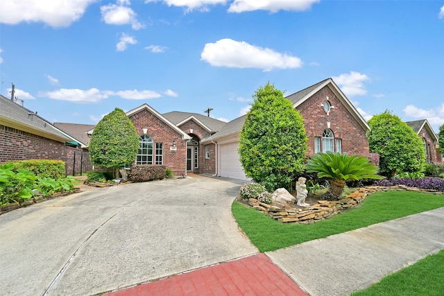 408 Pine Creek Dr, Friendswood, TX 77546 - view of front of property with brick siding, an attached garage, and concrete driveway