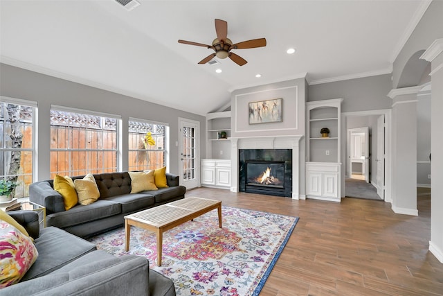 408 Pine Creek Dr, Friendswood, TX 77546 - living room with ceiling fan, wood finished floors, a glass covered fireplace, built in shelves, and baseboards