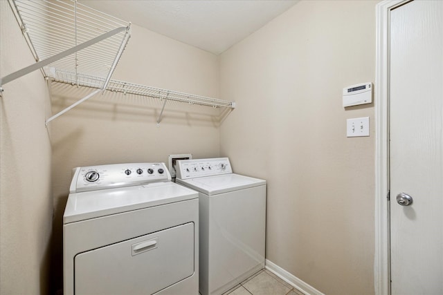 29422 Legends Line Dr, Spring, TX 77386 - laundry room featuring separate washer and dryer, baseboards, and light tile patterned floors