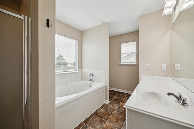 29422 Legends Line Dr, Spring, TX 77386 - bathroom with plenty of natural light, vanity, a garden tub, and tile patterned flooring