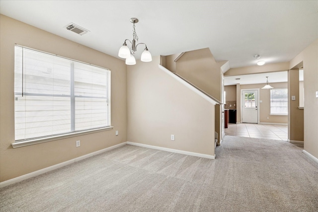 29422 Legends Line Dr, Spring, TX 77386 - empty room with a chandelier, light colored carpet, stairway, and baseboards