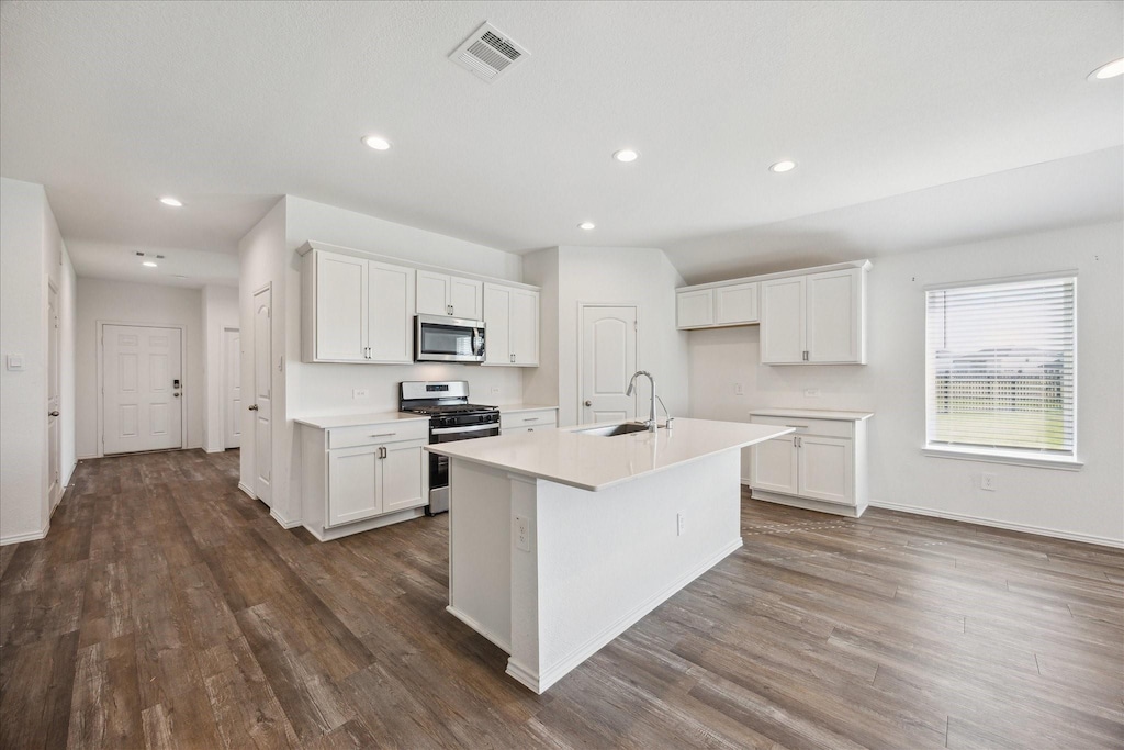 5005 Almond Terrace Dr, Katy, TX 77493 - kitchen with appliances with stainless steel finishes, a sink, dark wood-type flooring, white cabinets, and light countertops