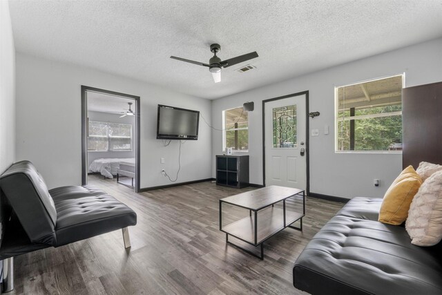 541 Trails End Dr, Cleveland, TX 77328 - living area with ceiling fan, healthy amount of natural light, wood finished floors, a textured ceiling, and baseboards