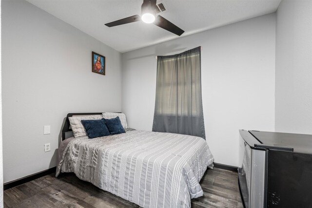 541 Trails End Dr, Cleveland, TX 77328 - bedroom featuring dark wood-style floors, a ceiling fan, and baseboards