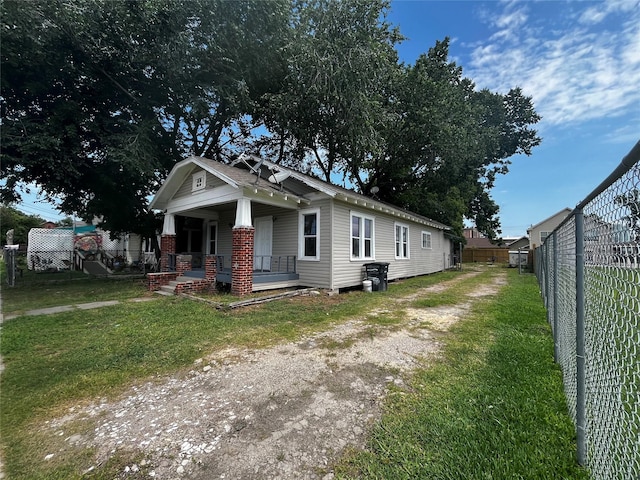 6015 Brady St, Houston, TX 77011 - view of side of home featuring covered porch and driveway