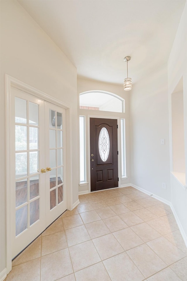 2630 Sable Ridge Ln, Katy, TX 77494 - foyer entrance with light tile patterned flooring, french doors, and baseboards