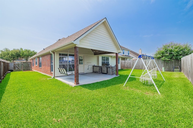 2630 Sable Ridge Ln, Katy, TX 77494 - back of property featuring a patio, brick siding, and a shingled roof
