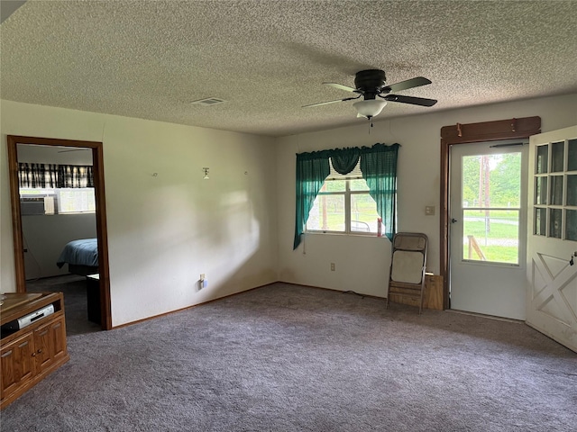 7719 County Road 233, Centerville, TX 75833 - unfurnished living room with ceiling fan, carpet floors, a textured ceiling, and cooling unit