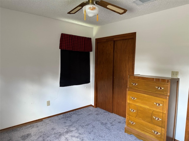 7719 County Road 233, Centerville, TX 75833 - bedroom featuring carpet, a textured ceiling, baseboards, a ceiling fan, and a closet