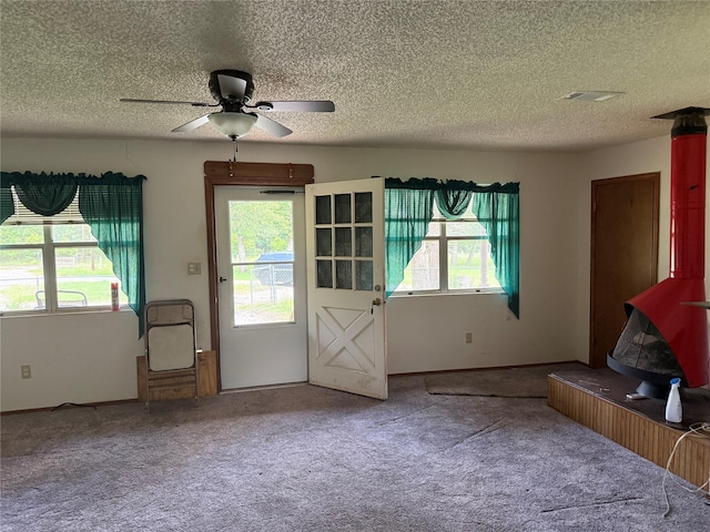 7719 County Road 233, Centerville, TX 75833 - entryway featuring a textured ceiling, carpet, and a ceiling fan