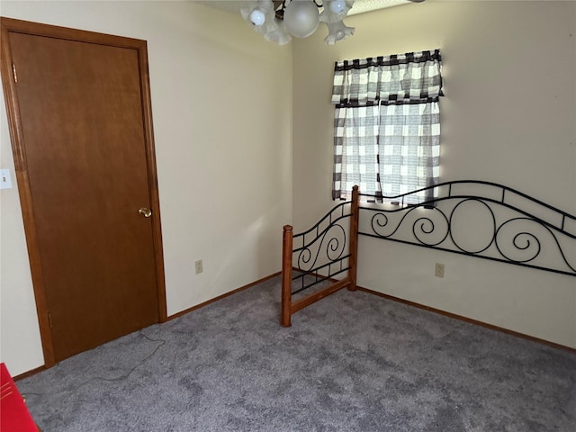7719 County Road 233, Centerville, TX 75833 - unfurnished bedroom with carpet flooring, a chandelier, and baseboards