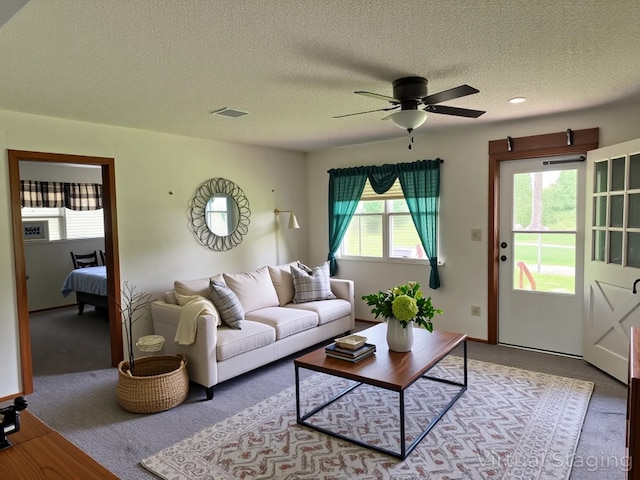 7719 County Road 233, Centerville, TX 75833 - living area with light colored carpet, a ceiling fan, and a textured ceiling